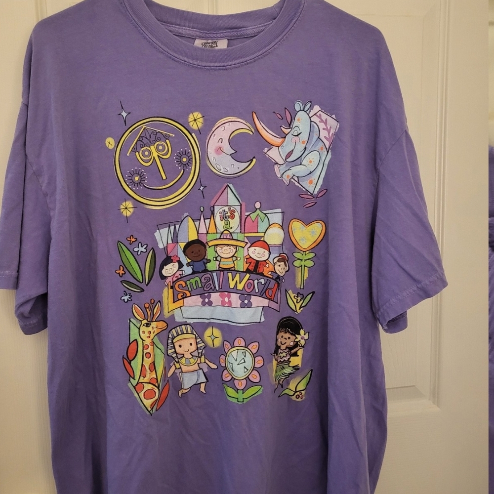 It's A Small World Comfort Colors Purple Short Sleeve Tee with Whimsical Design